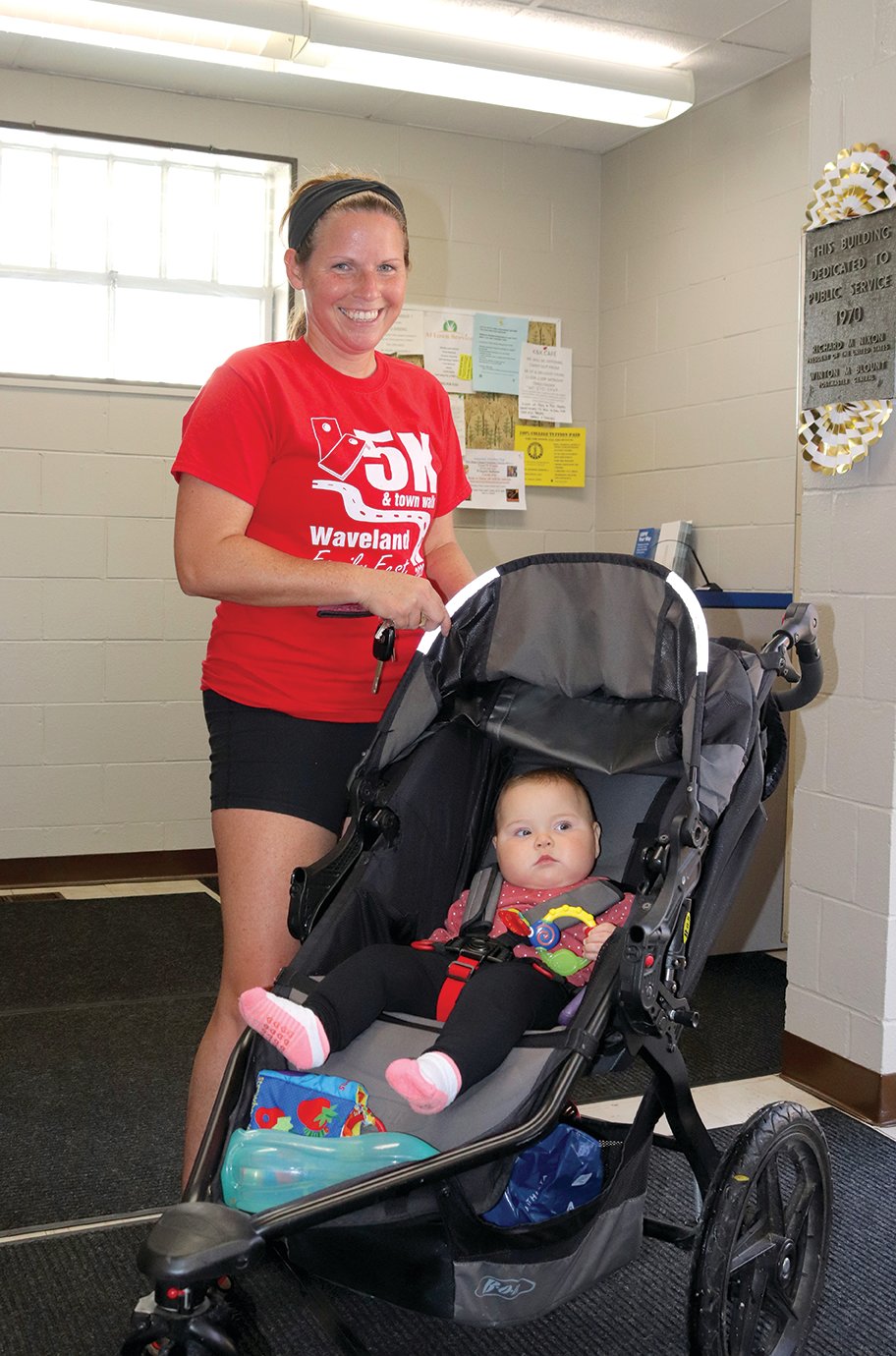 Wingate resident Mindy Nichols and her seven-month-old daughter Madison visit the Wingate Post Office Thursday. Members of the Nichols family and many others make routine stops at the post office, sometimes simply to see Postmaster Jennifred Jones and others in the community.